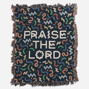 Blanket with 'PRAISE THE LORD' text and colorful patterns on a dark background