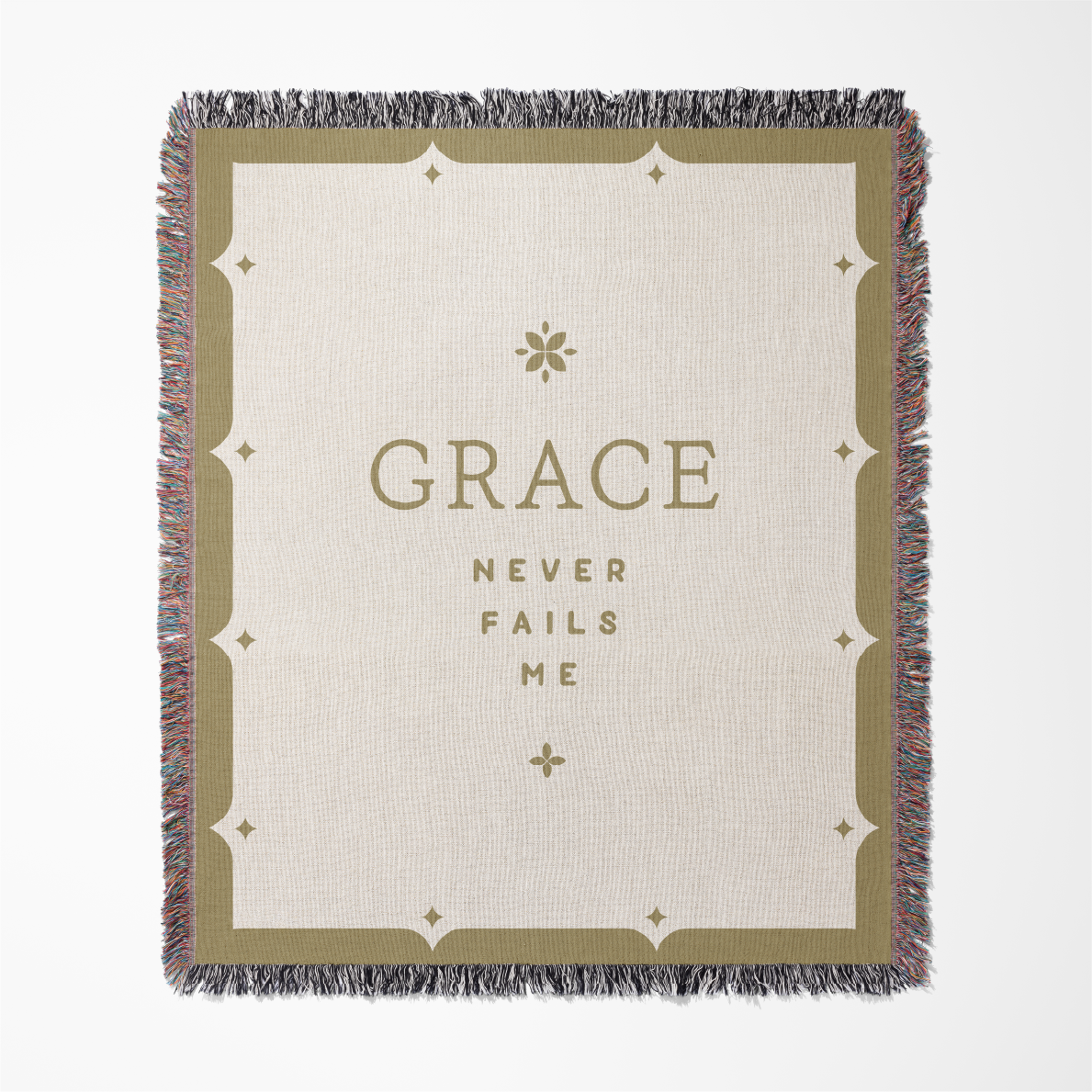 Blanket with 'GRACE NEVER FAILS ME' text on a white background