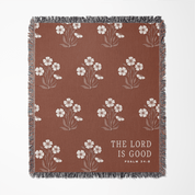 Brown blanket with floral pattern and 'The Lord is Good' text on a white background