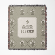 Decorative blanket with floral patterns and text on a light green background