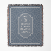 Decorative throw blanket with text and pattern on a white background