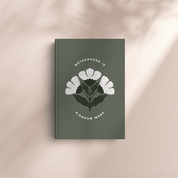 Book with floral design and text on a beige background