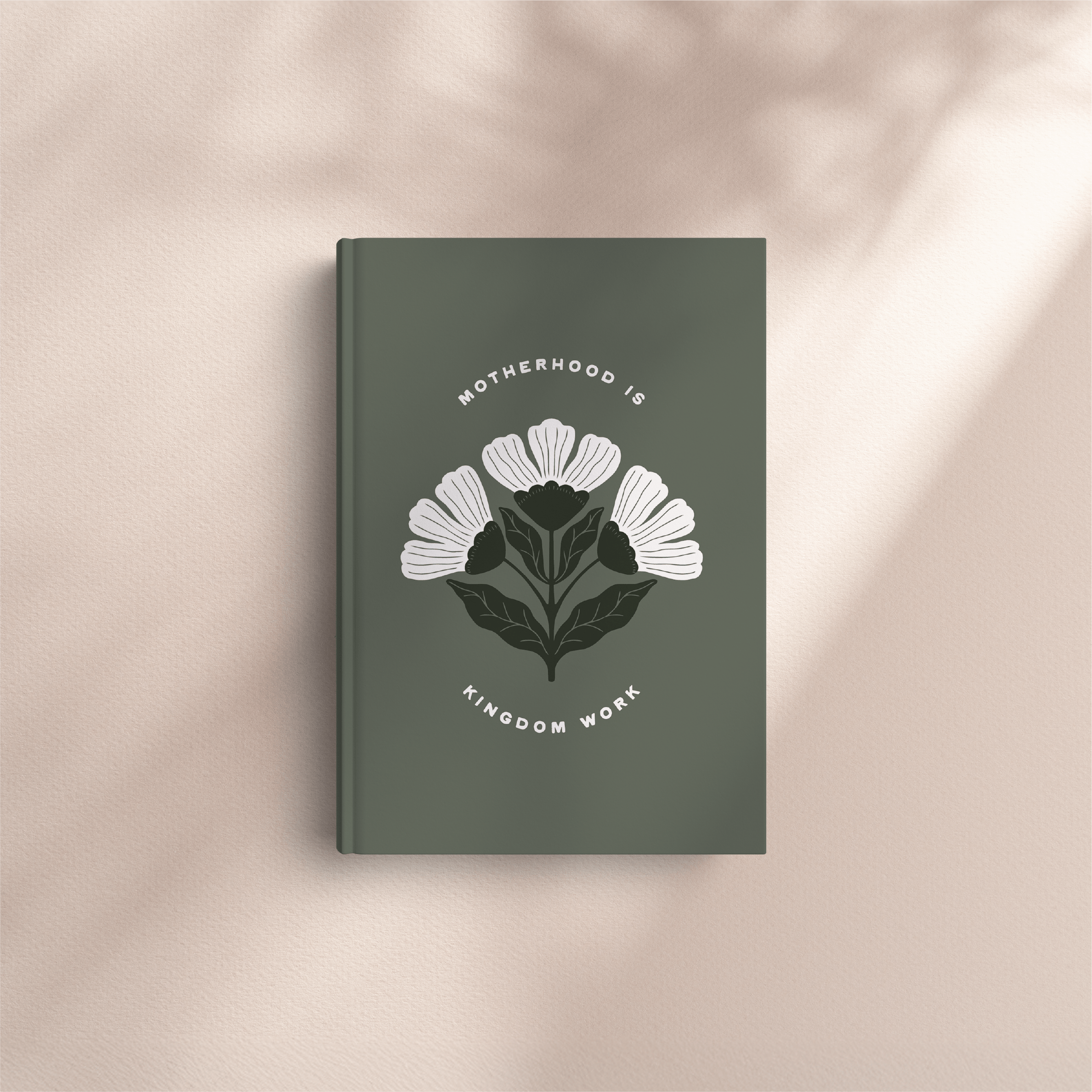 Book with floral design and text on a beige background