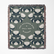 Decorative throw blanket with floral pattern and text on a white background