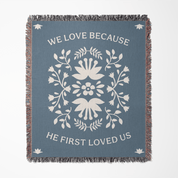 Decorative throw blanket with floral design and text on a blue background