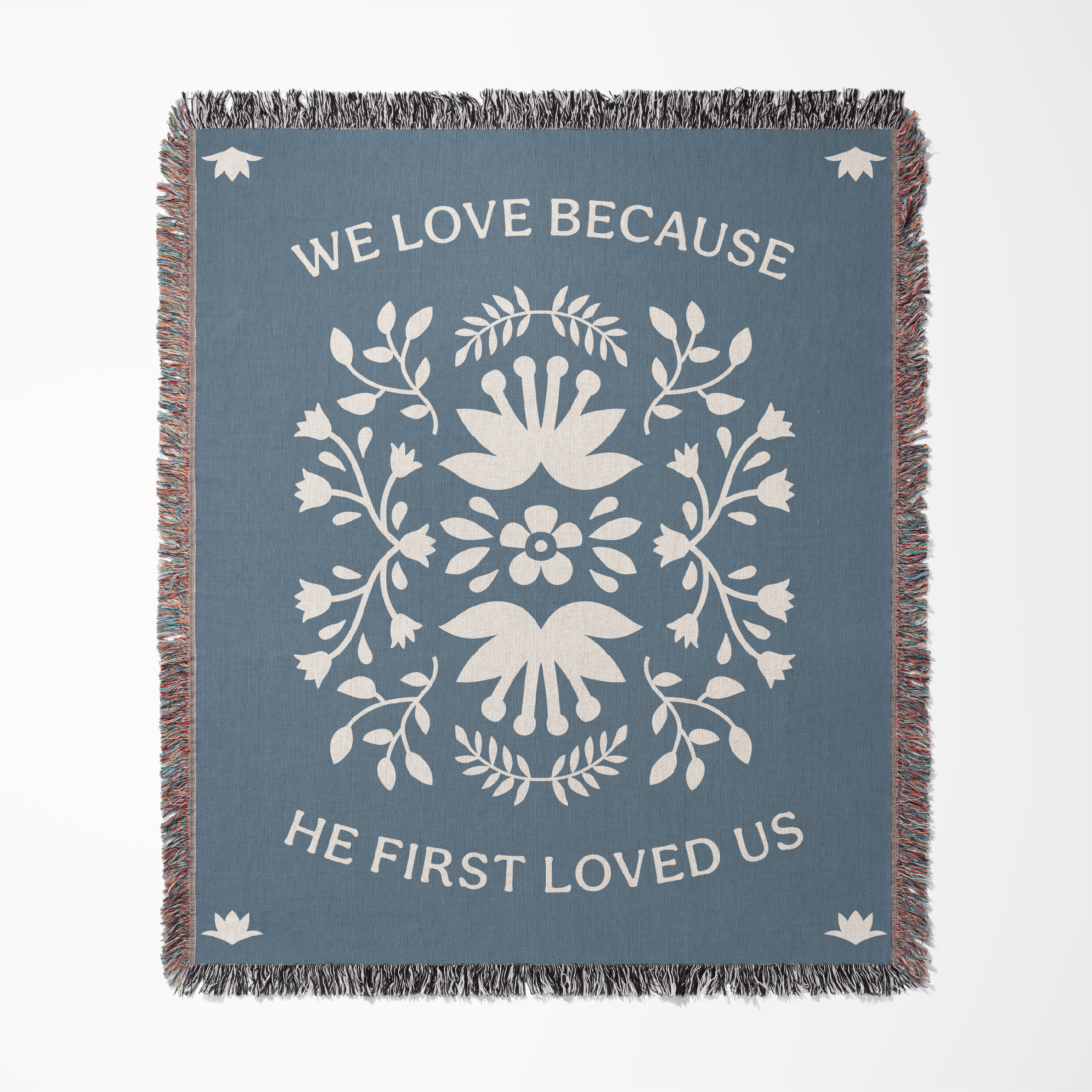 Decorative throw blanket with floral design and text on a blue background