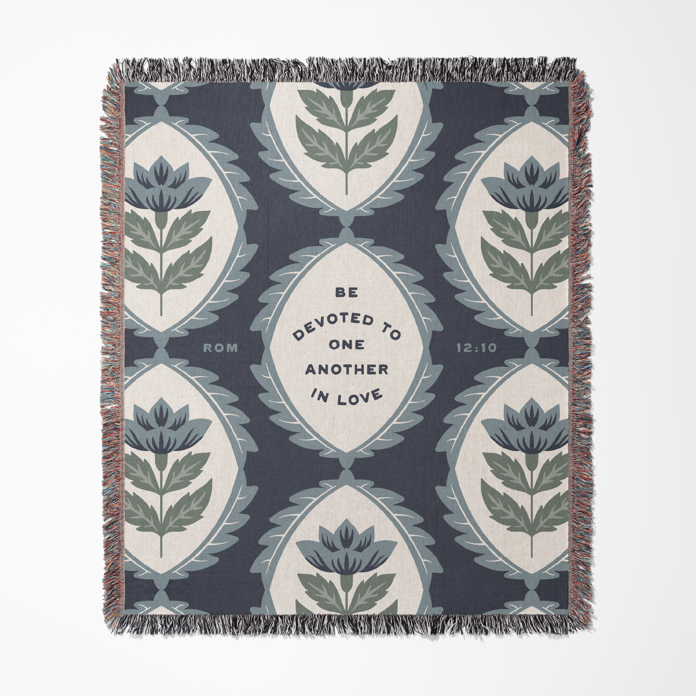 Decorative blanket with floral pattern and text on a white background