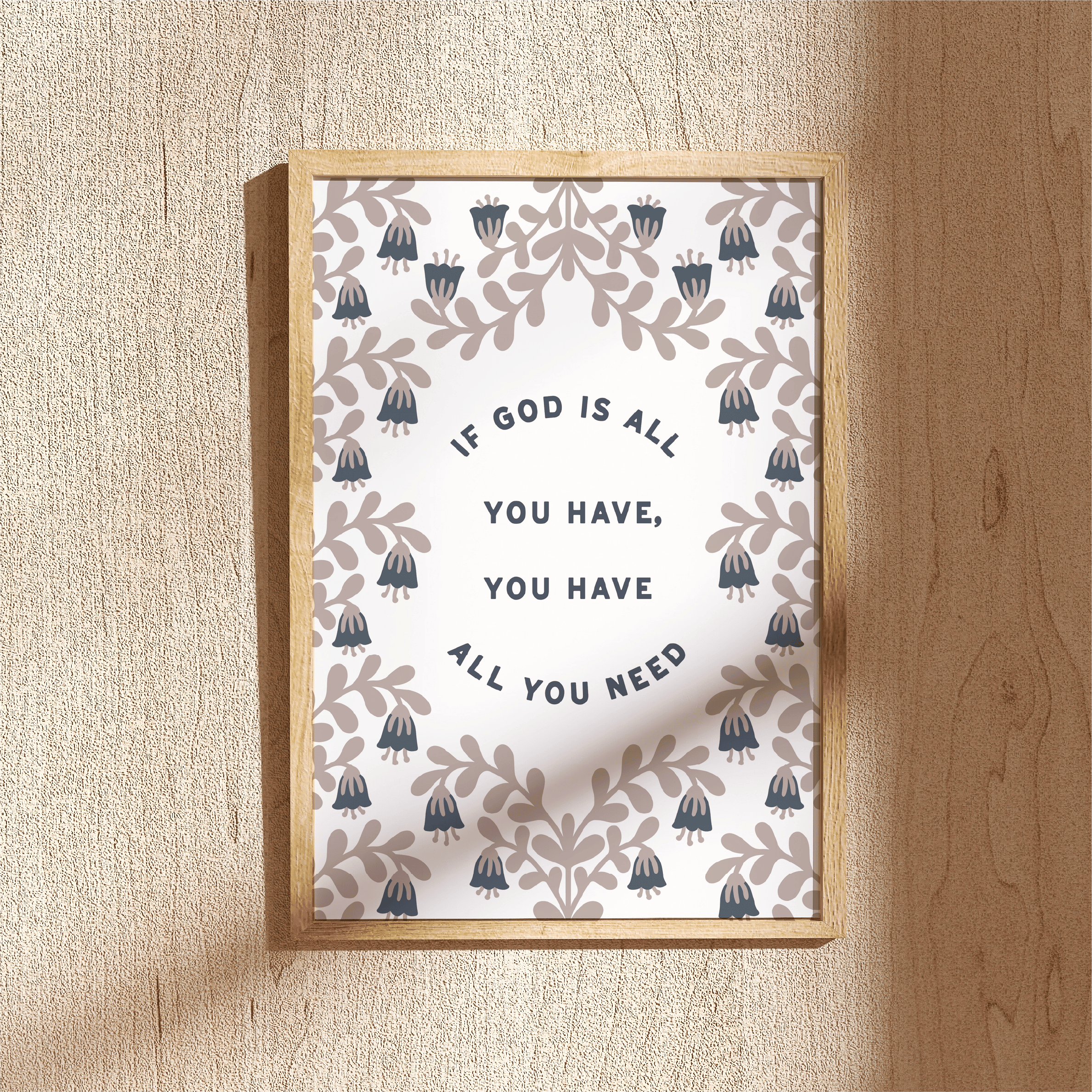 Framed print with decorative design and motivational quote on a wooden surface