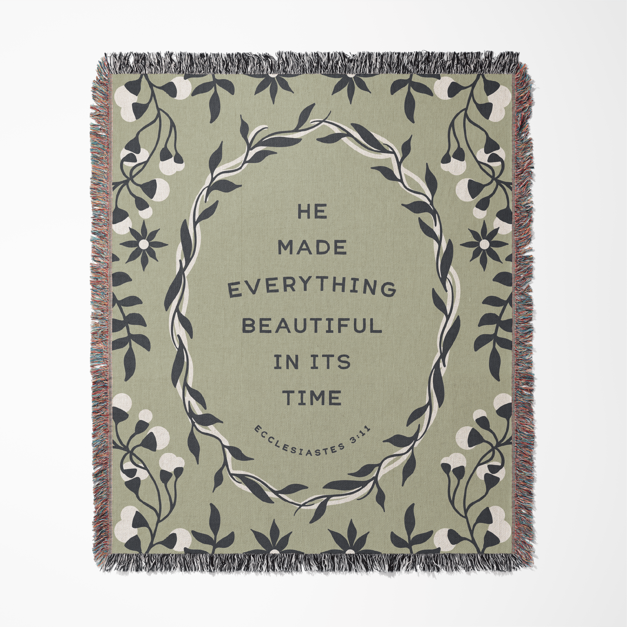 Decorative throw blanket with floral design and text on a white background