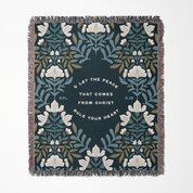 Decorative blanket with floral pattern and inspirational text on a white background