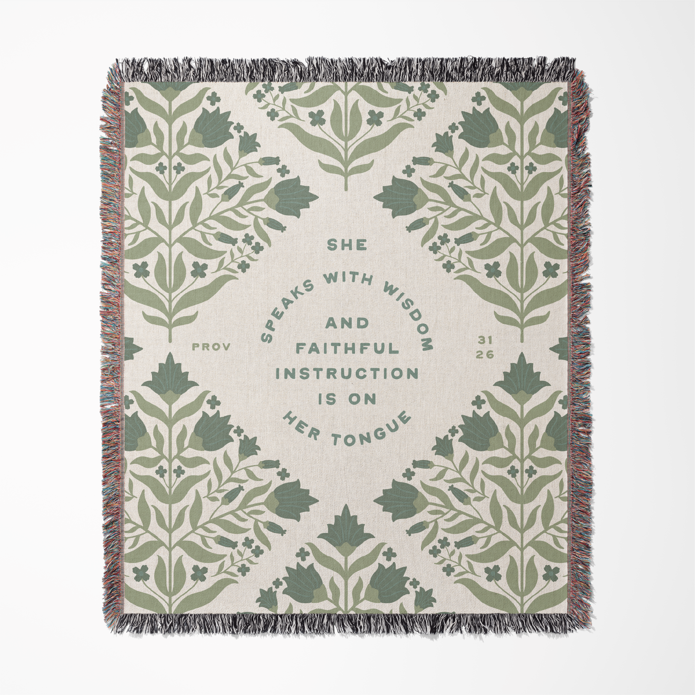 Decorative throw blanket with green leaf pattern and text on a beige background
