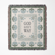 Decorative throw blanket with text 'God always makes a way' and geometric patterns on a white background