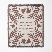Blanket with leaf pattern and text 'For I know the plans I have for you' on a white background