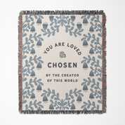Blanket with floral patterns and motivational text on a white background