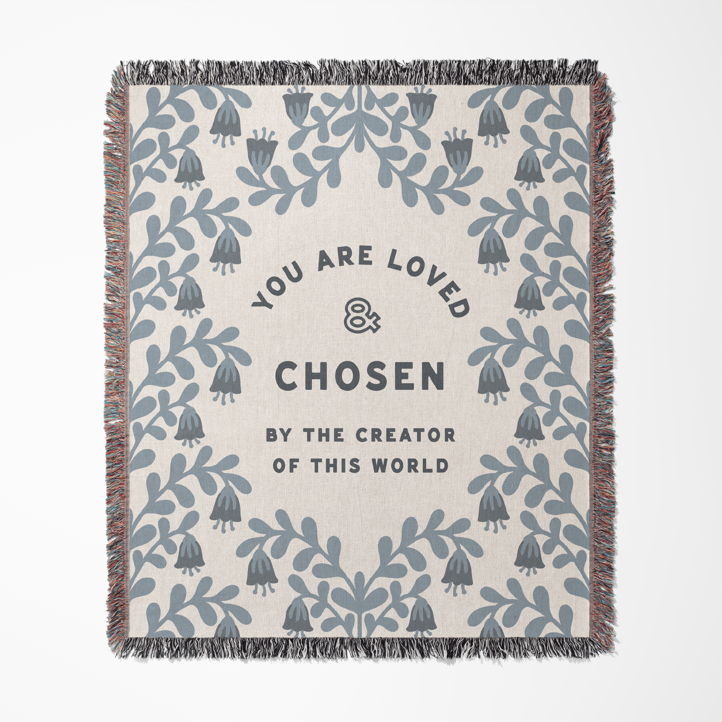 Blanket with floral patterns and motivational text on a white background