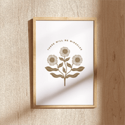 Framed artwork with floral design and text on a textured wall.