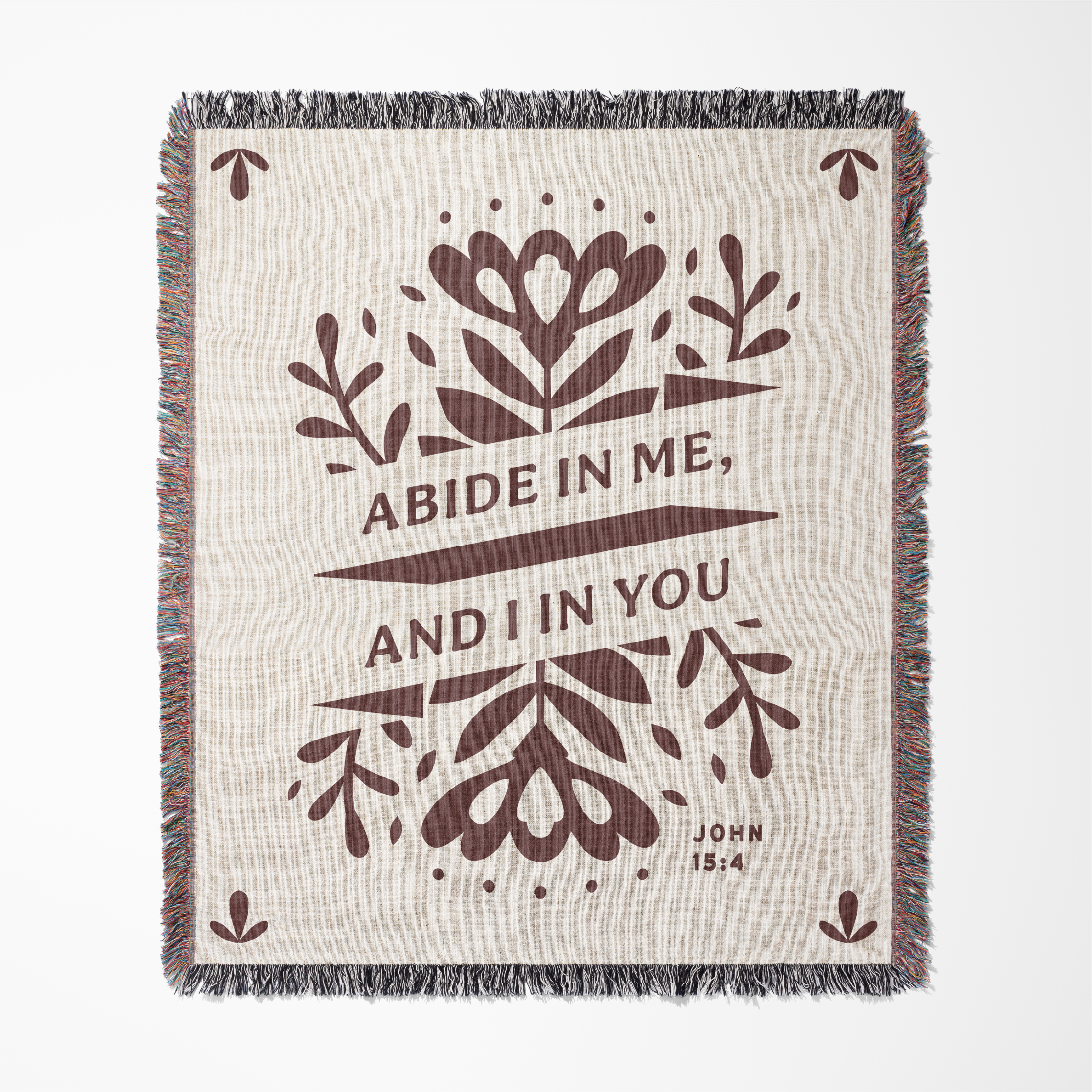 Woven blanket with floral design and text on a white background