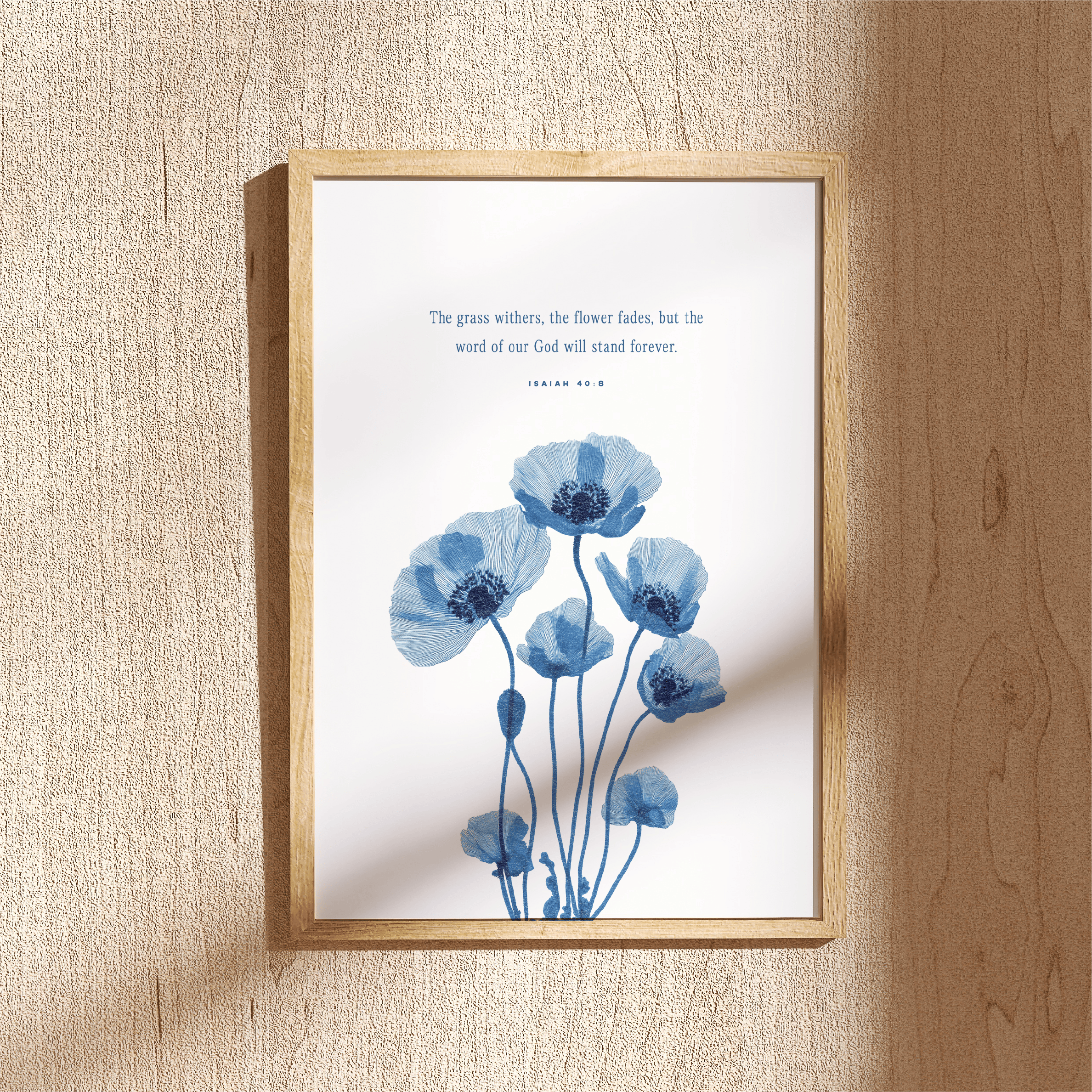 Framed artwork with blue floral design and text on a beige wall.