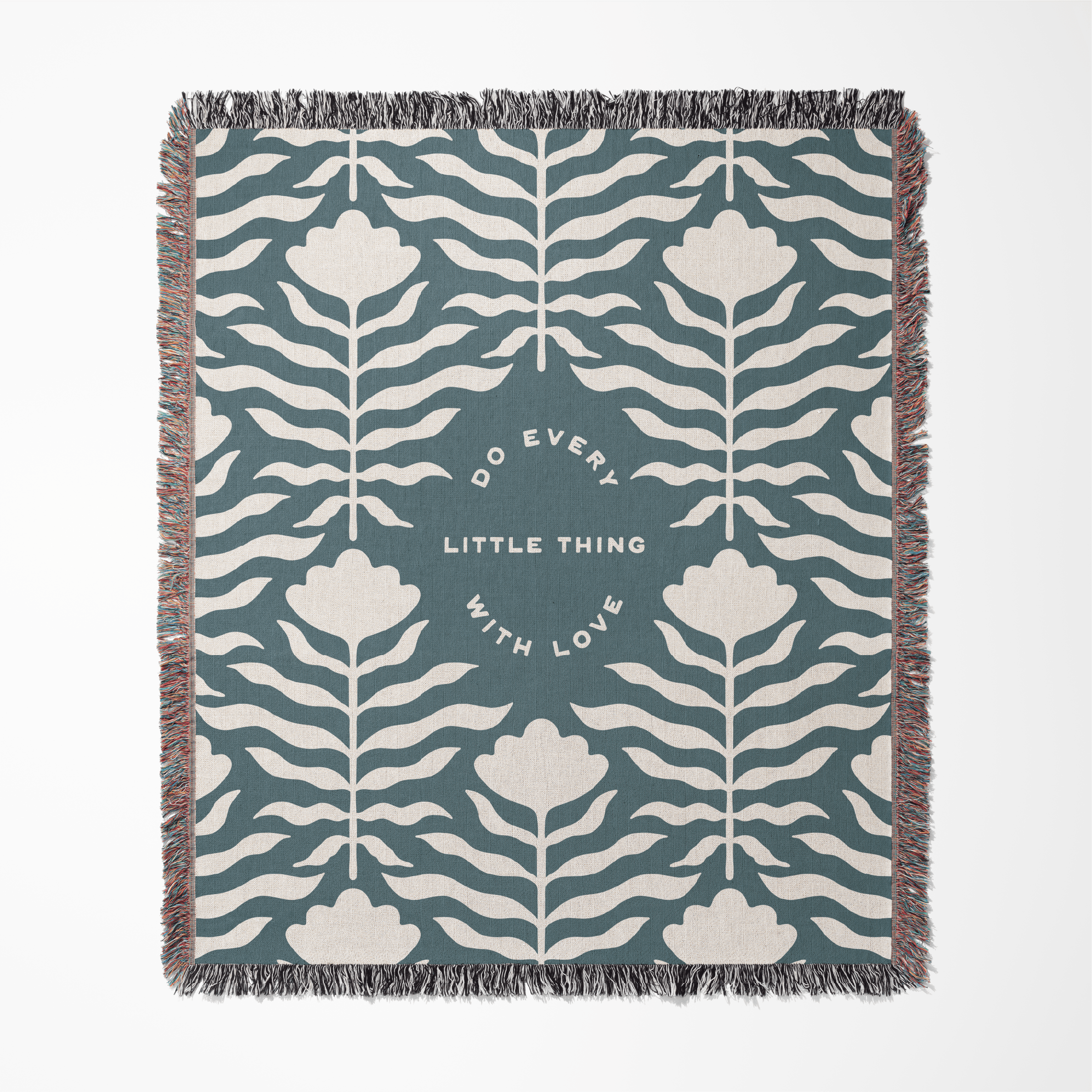 Decorative blanket with floral pattern and text on a white background