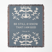 Decorative blanket with floral patterns and text on a blue background