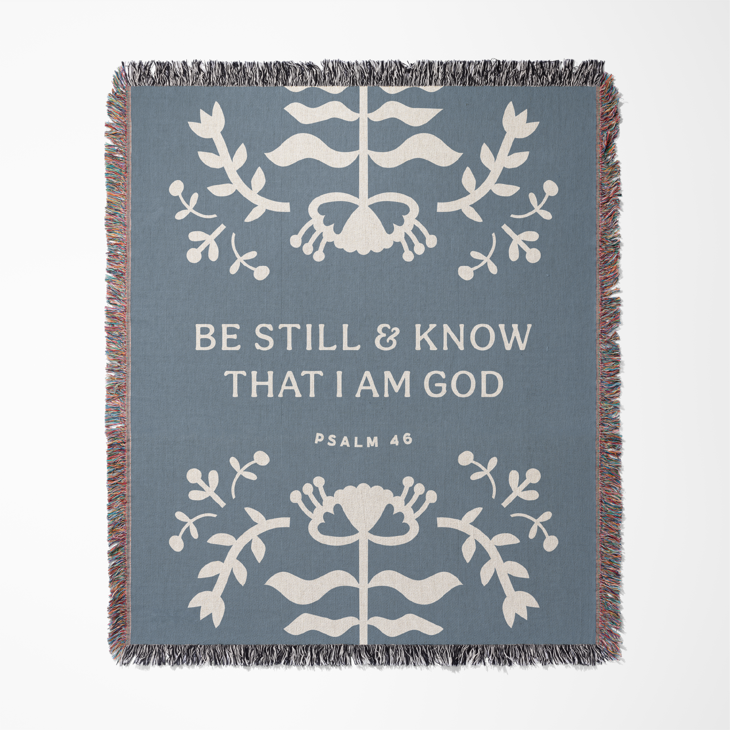 Decorative blanket with floral patterns and text on a blue background