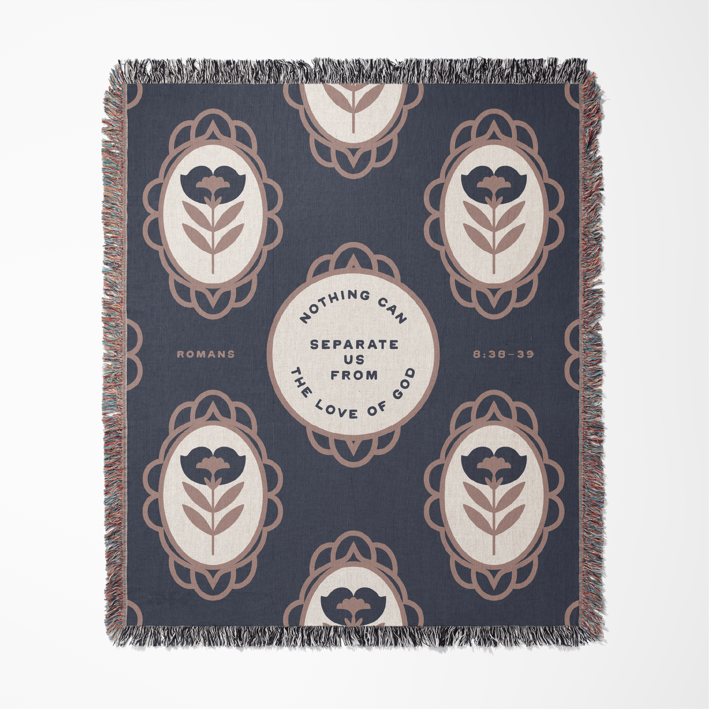 Decorative throw blanket with floral patterns and text on a blue background