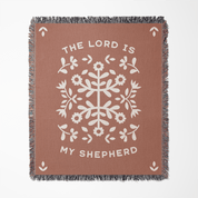 Brown blanket with white floral pattern and 'The Lord is My Shepherd' text on a white background