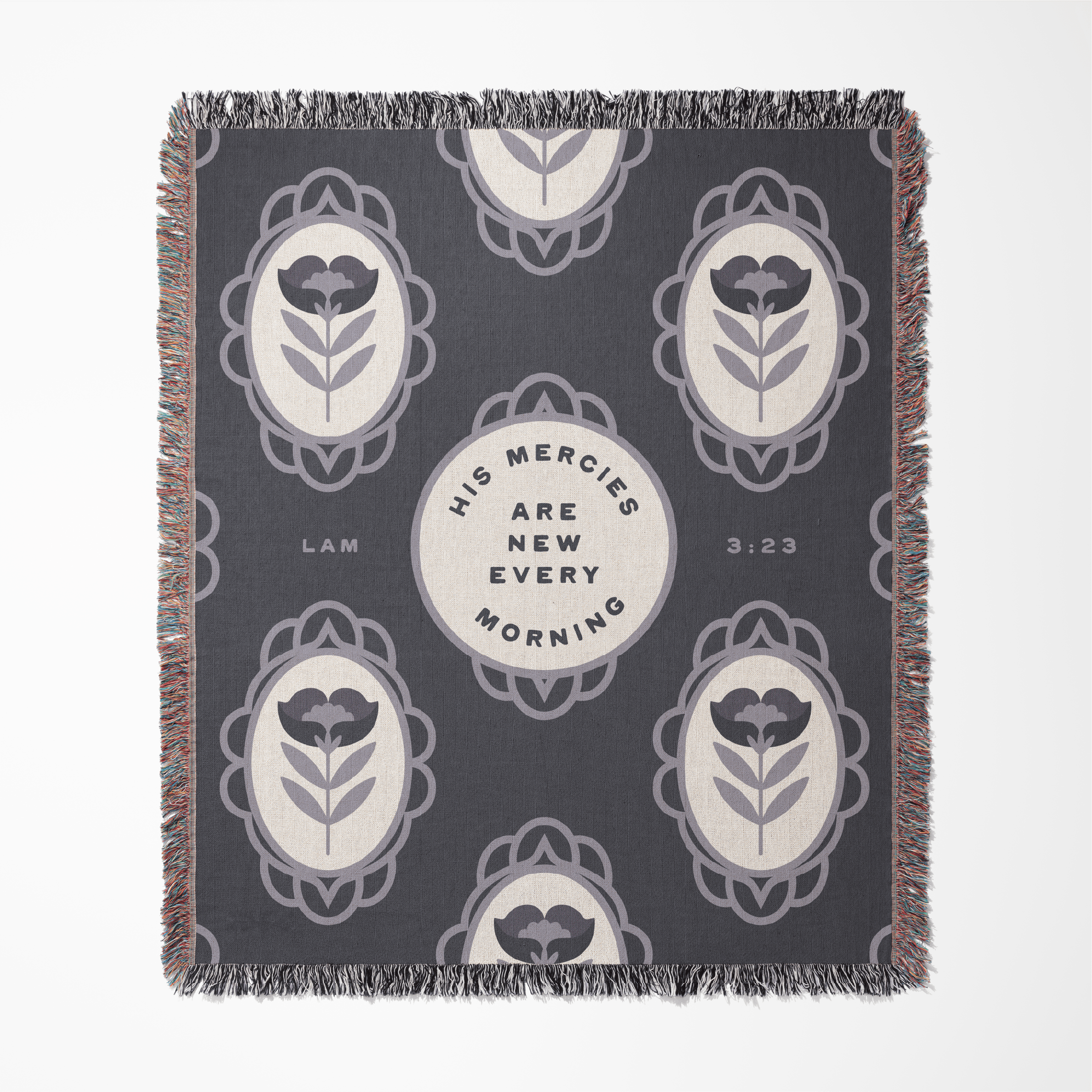 Decorative throw blanket with floral patterns and text on a blue background