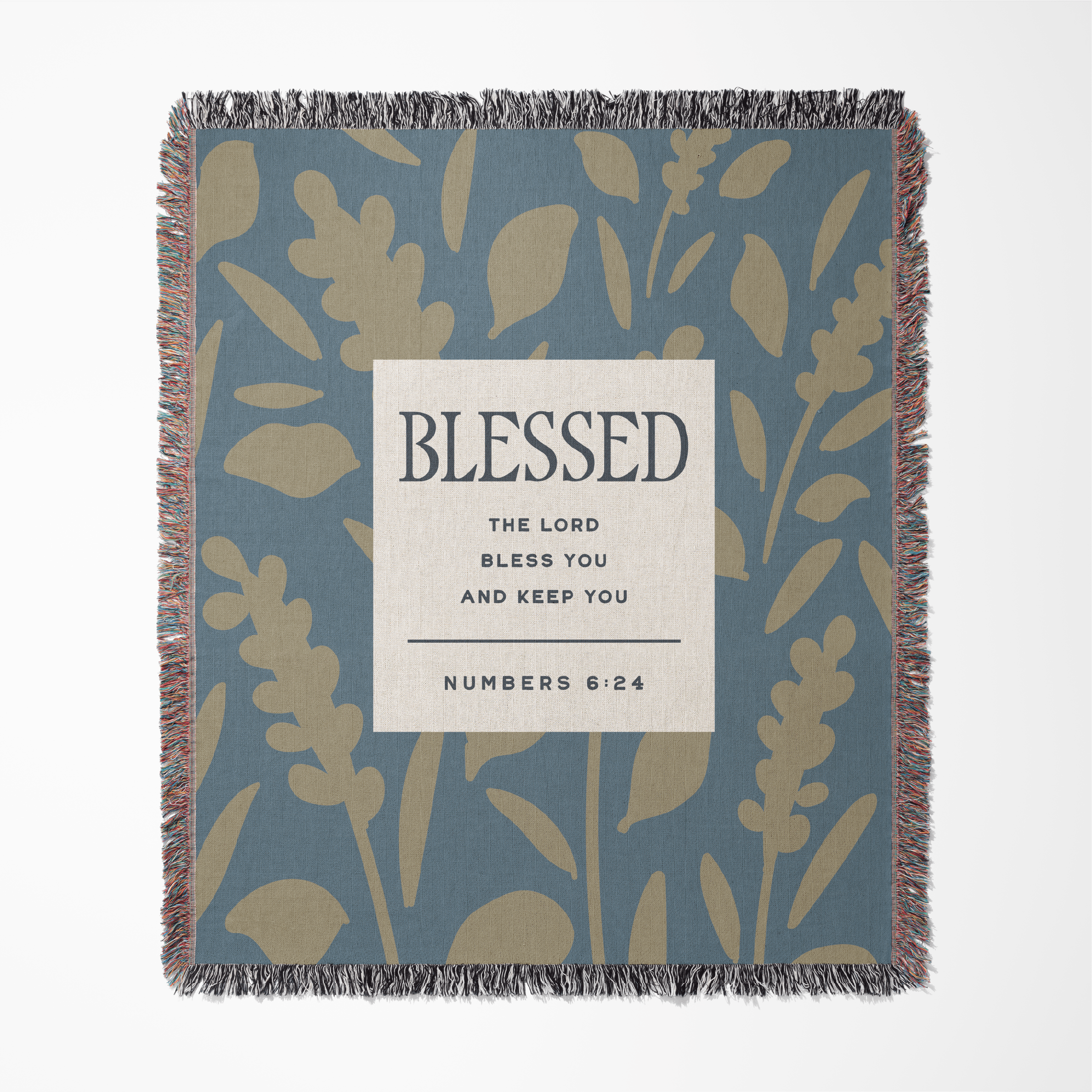 Blanket with leaf pattern and 'Blessed' text on a blue background