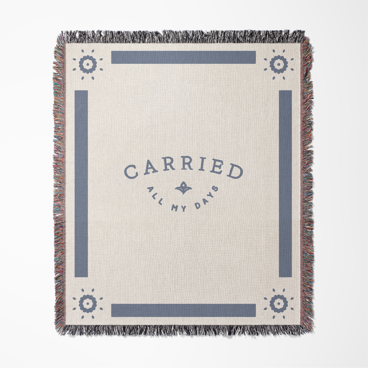 Blanket with 'Carried All My Days' text and decorative elements on a beige background
