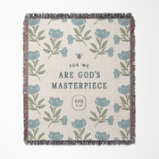 Blanket with floral pattern and text 'For we are God's Masterpiece Eph 2:10' on a white background