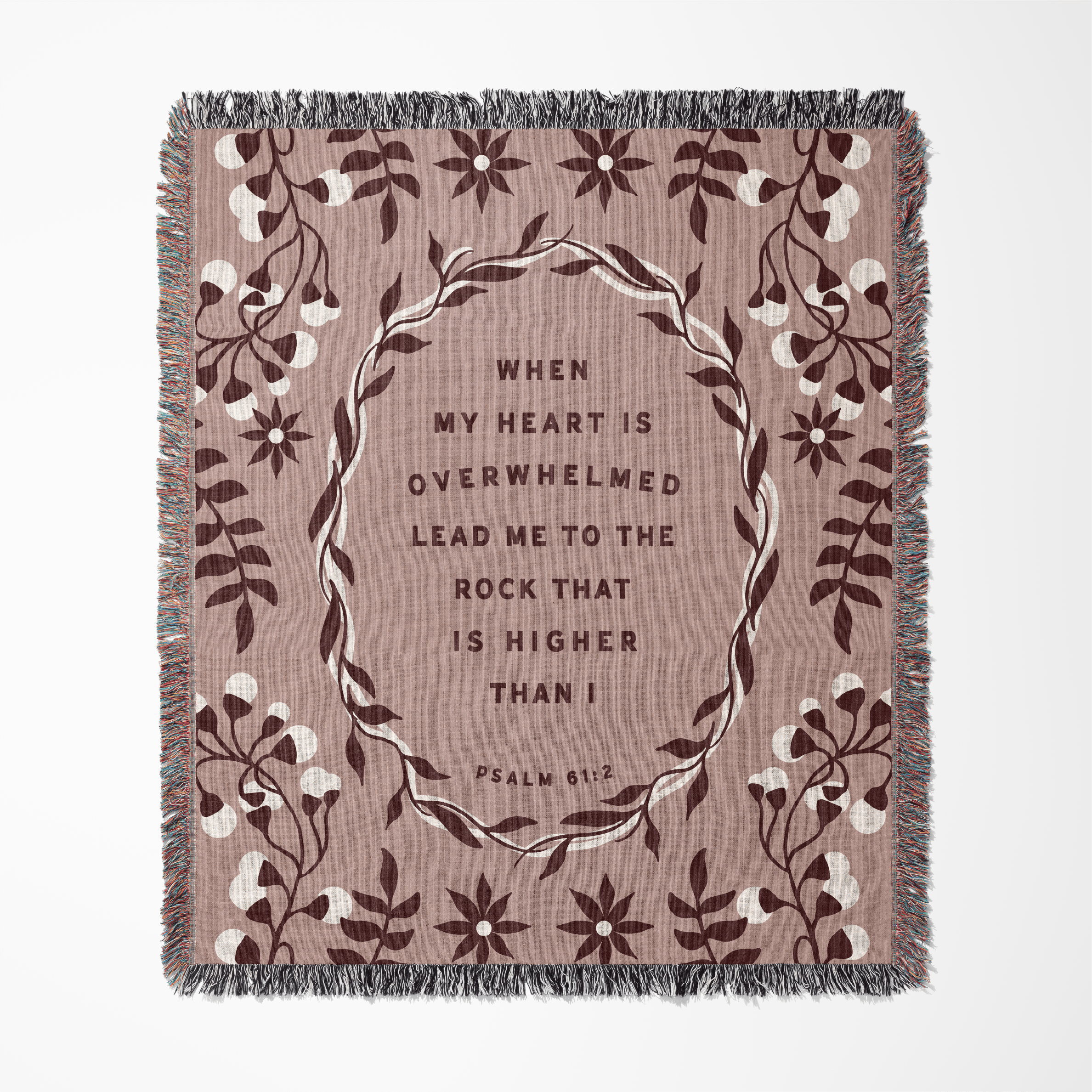 Decorative blanket with floral design and inspirational quote on a beige background