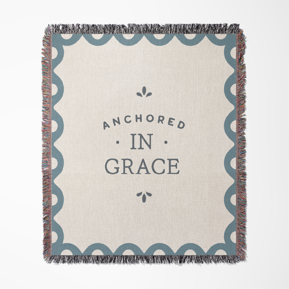 Blanket with 'Anchored in Grace' text on a white background
