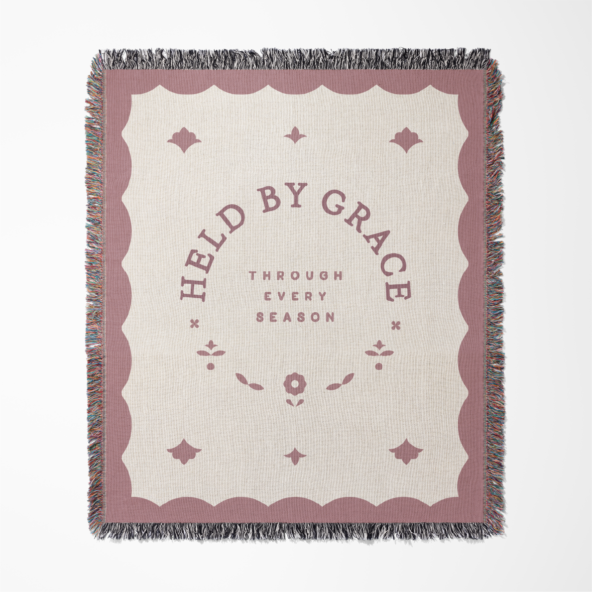 Blanket with 'Held by Grace' text on a white background