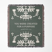 Blanket with floral patterns and motivational text on a green background
