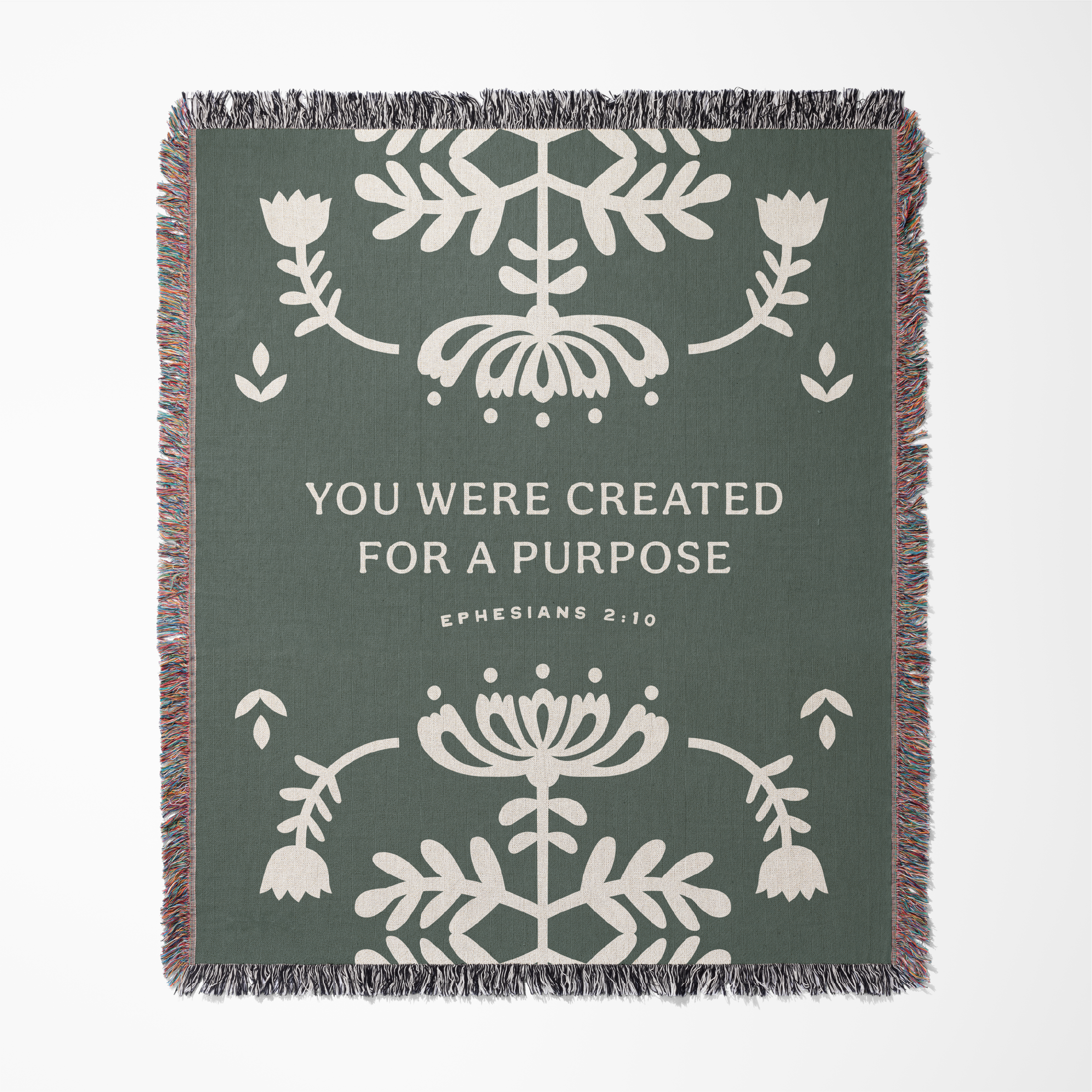 Blanket with floral patterns and motivational text on a green background