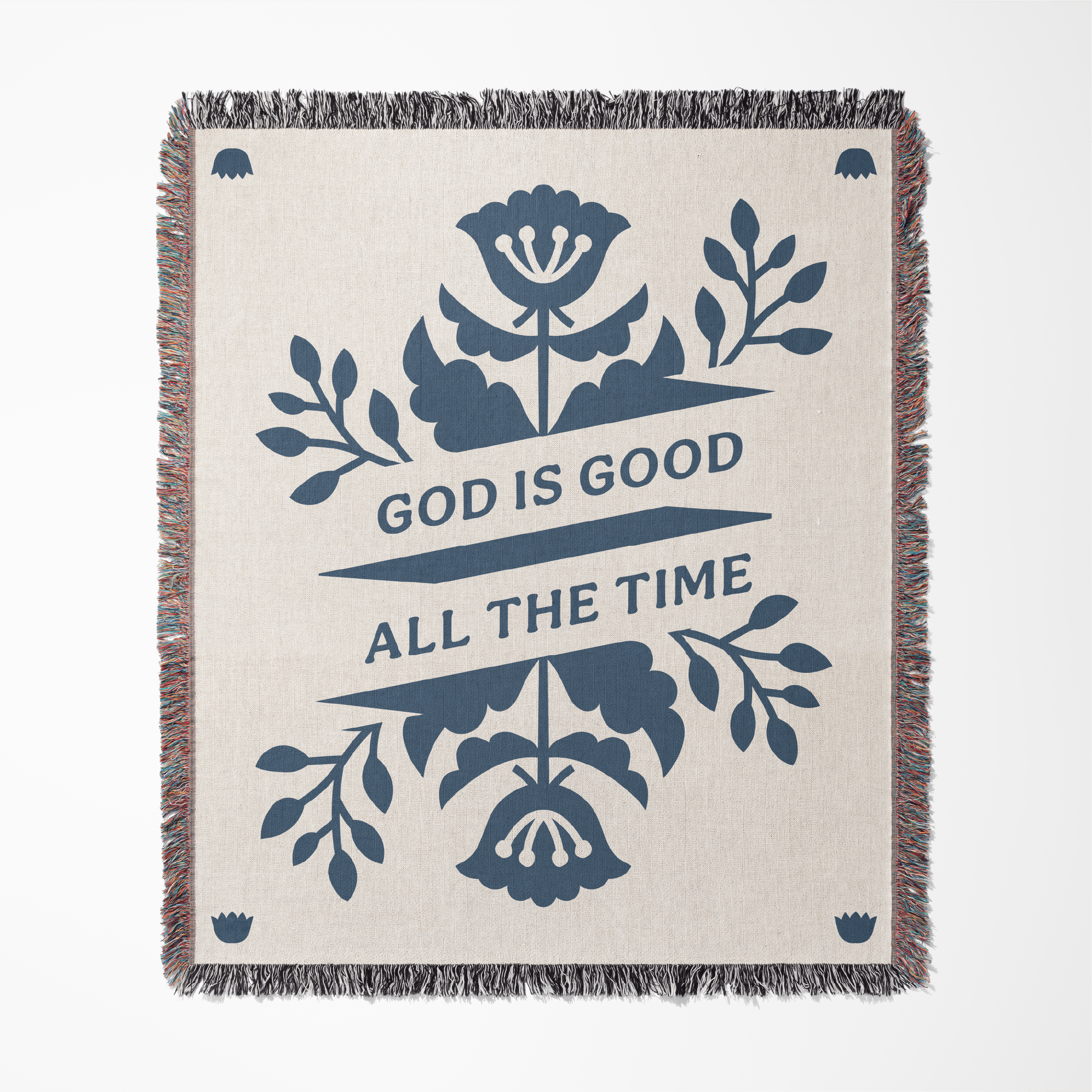 Blanket with floral design and 'God is Good All the Time' text on a white background