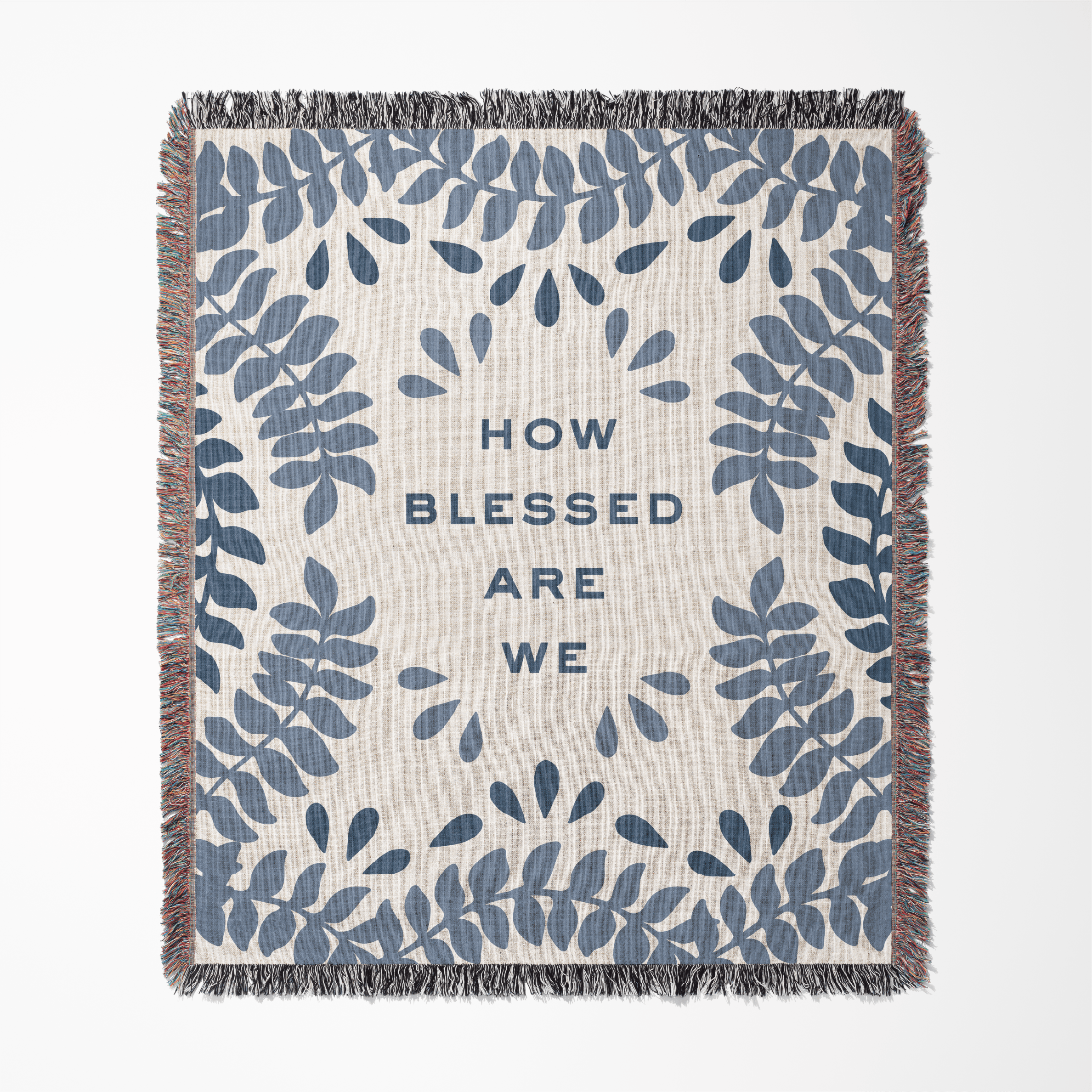 Blanket with blue leaf pattern and text 'How blessed are we' on a beige background