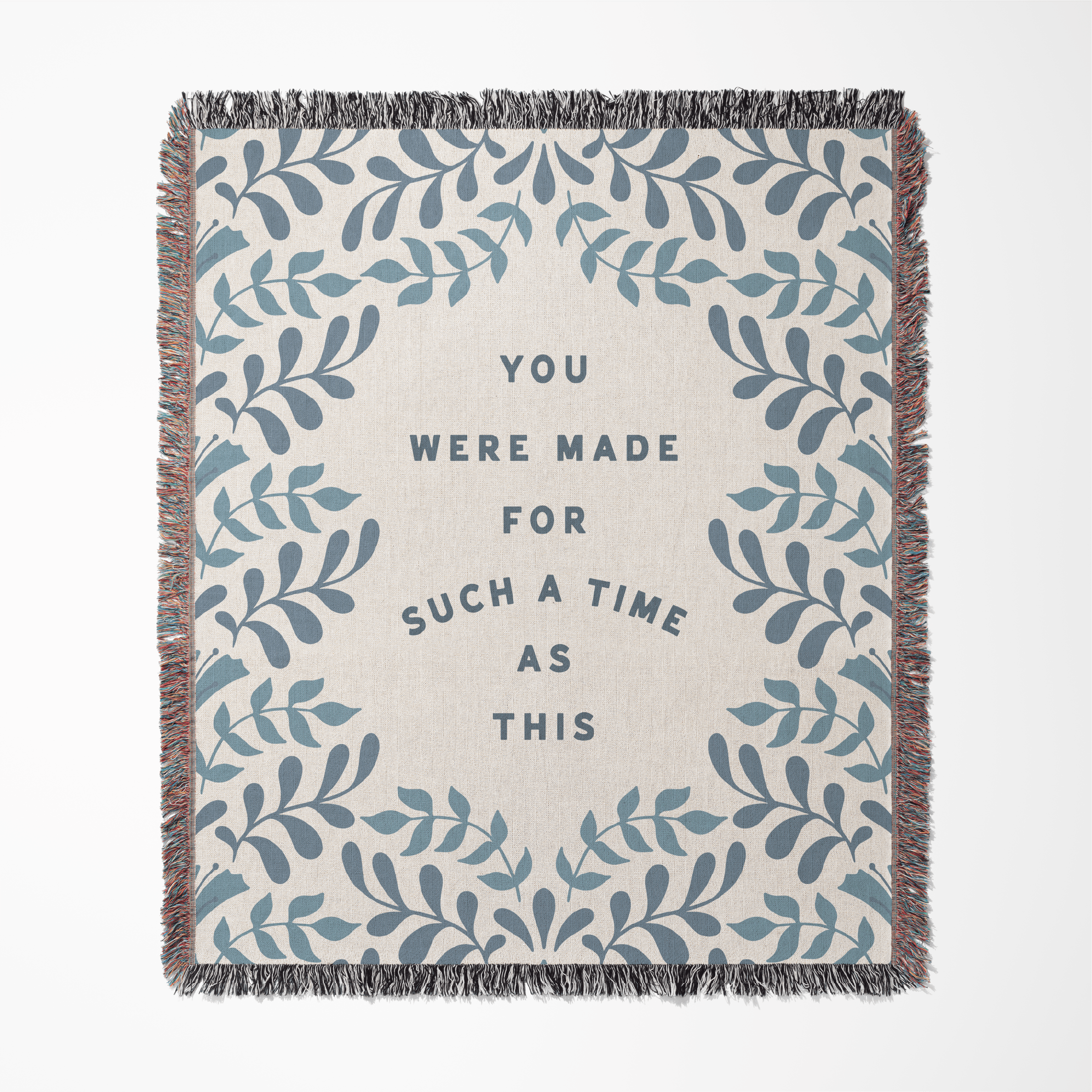 Blanket with leaf pattern and motivational quote on a white background