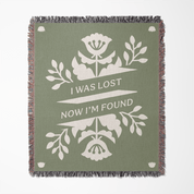 Green blanket with floral design and text 'I was lost now I'm found' on a white background