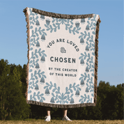 Blanket with motivational text and patterns in a natural setting