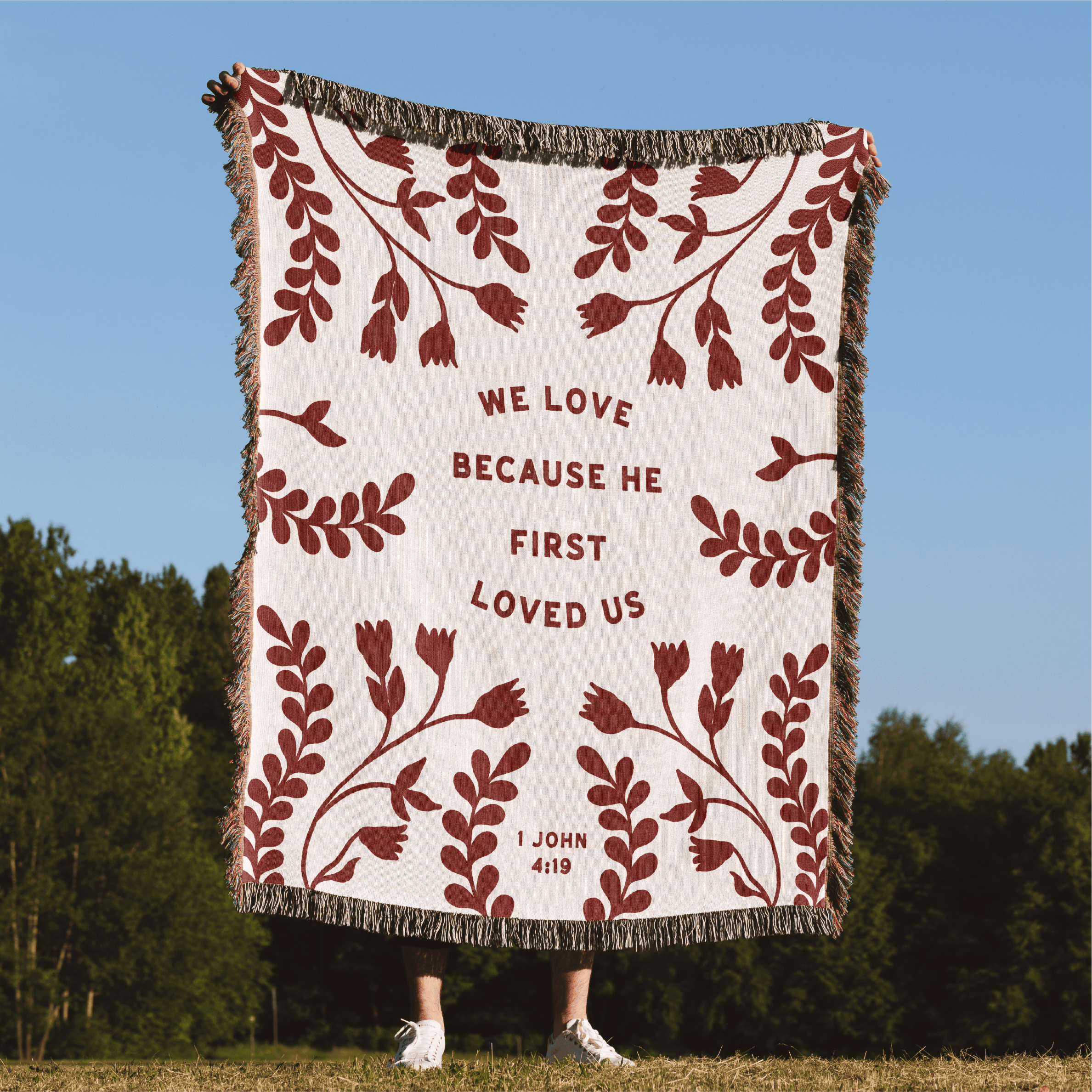 Blanket with floral pattern and text in a natural setting