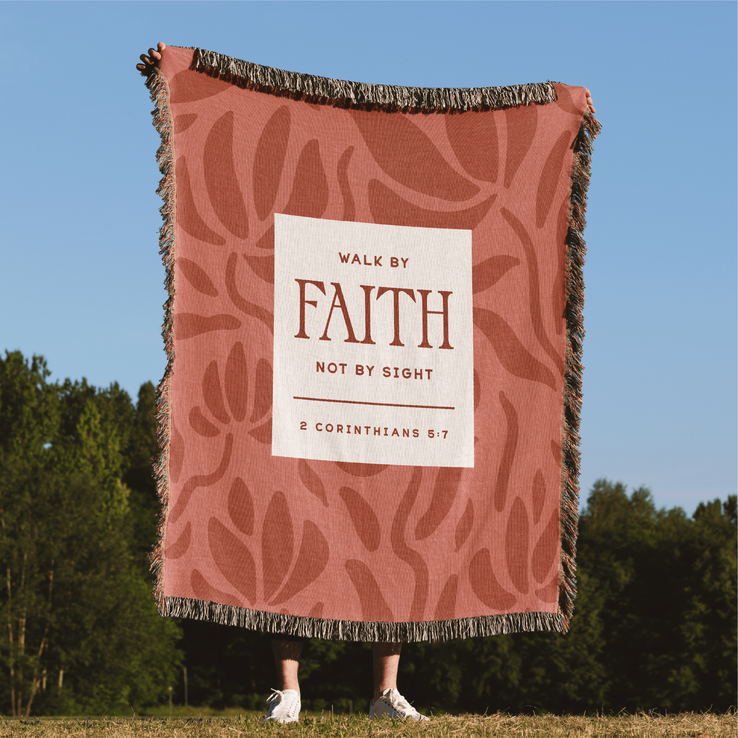 Blanket with 'Walk by Faith, Not by Sight' text in a scenic outdoor setting