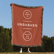 My Hope is Unshaken woven blanket held up in park