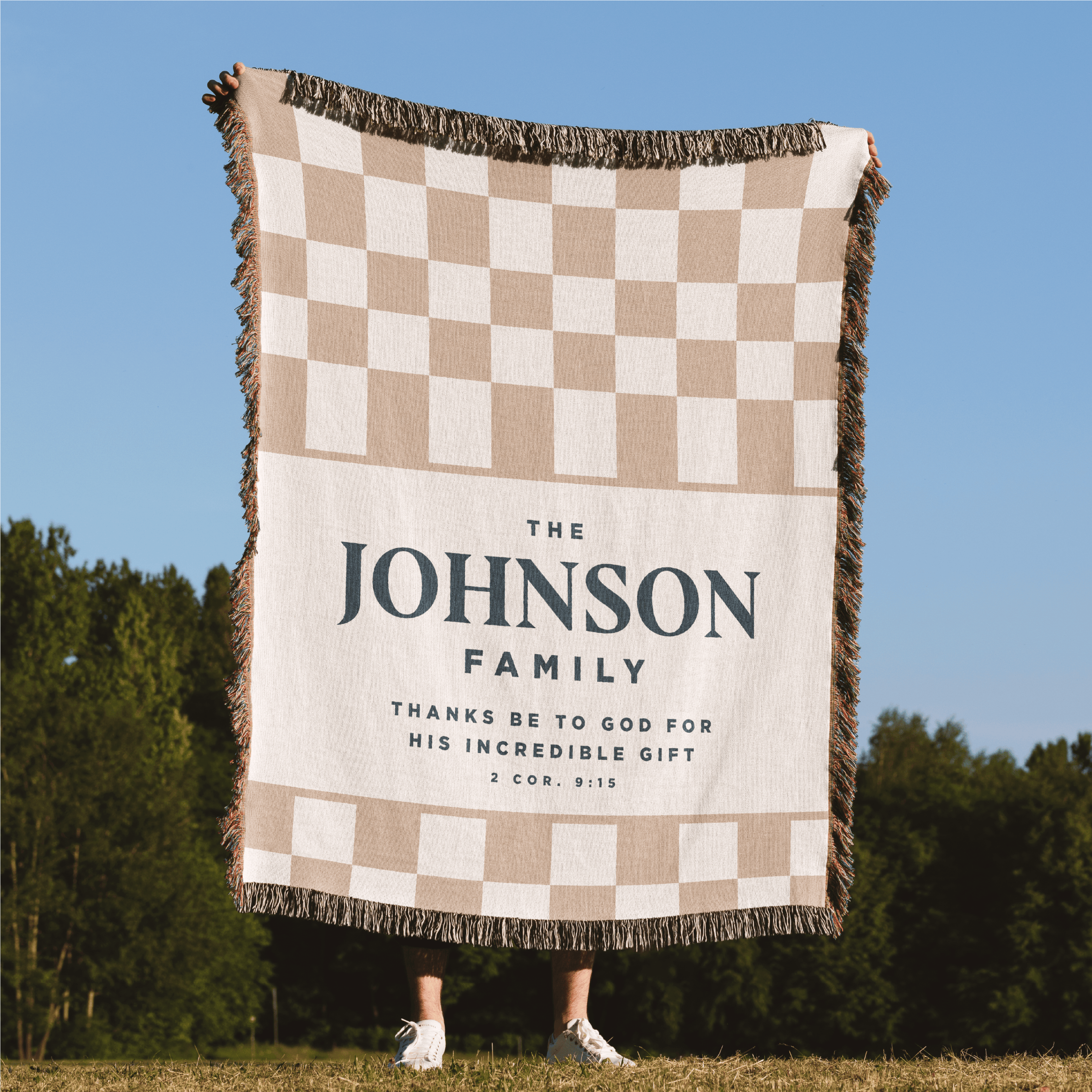 Checkered blanket with 'Johnson Family' text in a field