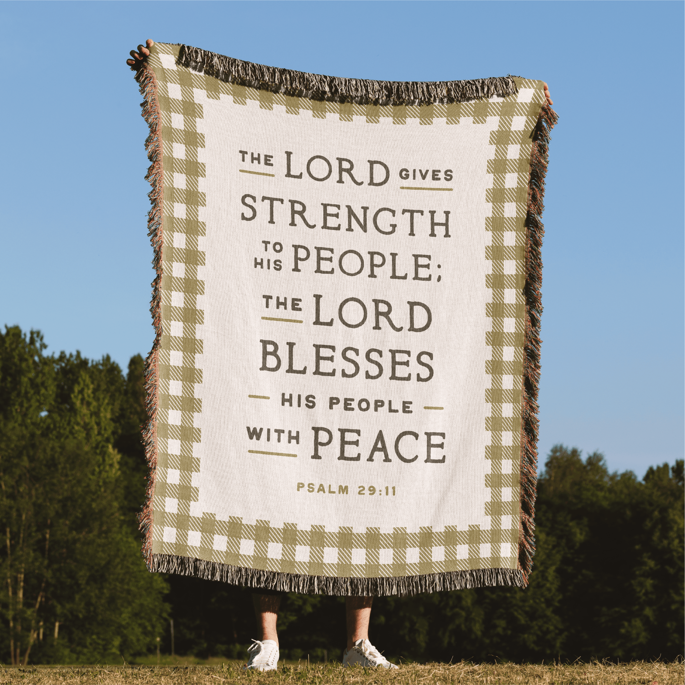 Blanket with biblical text against a natural background
