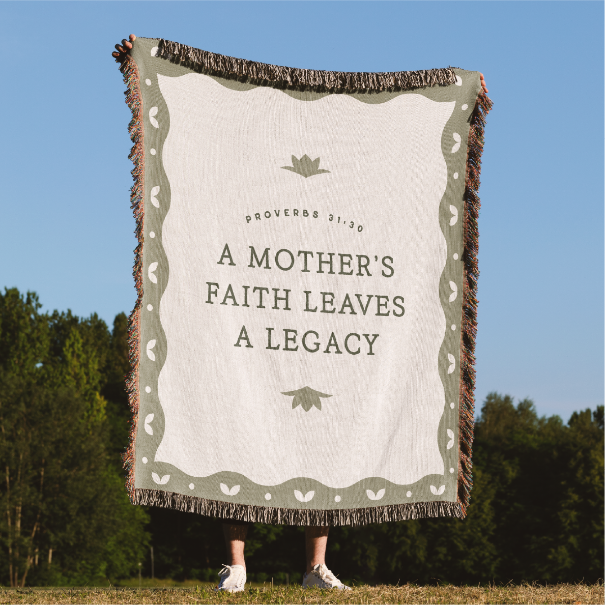 Blanket with 'A Mother's Faith Leaves a Legacy' text in a natural setting