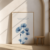 Framed artwork with blue floral design and text on a wall.