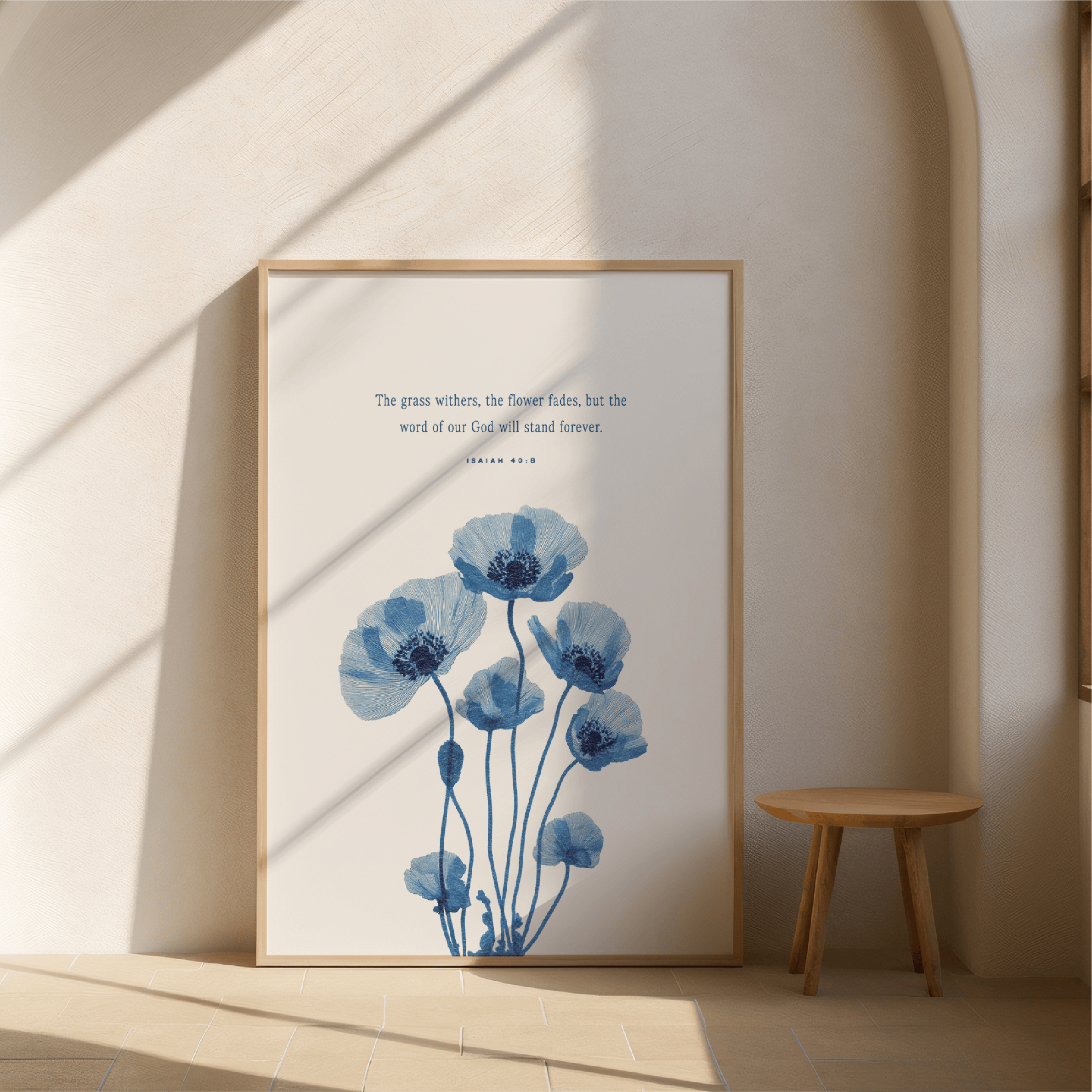 Framed artwork with blue floral design and text on a wall.