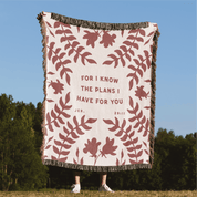 Blanket with floral pattern and text in a natural setting